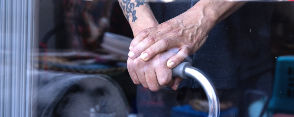 Senior hands holding cane