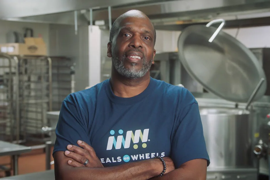 Black Male Volunteer poses in kitchen - Meals on Wheels America member