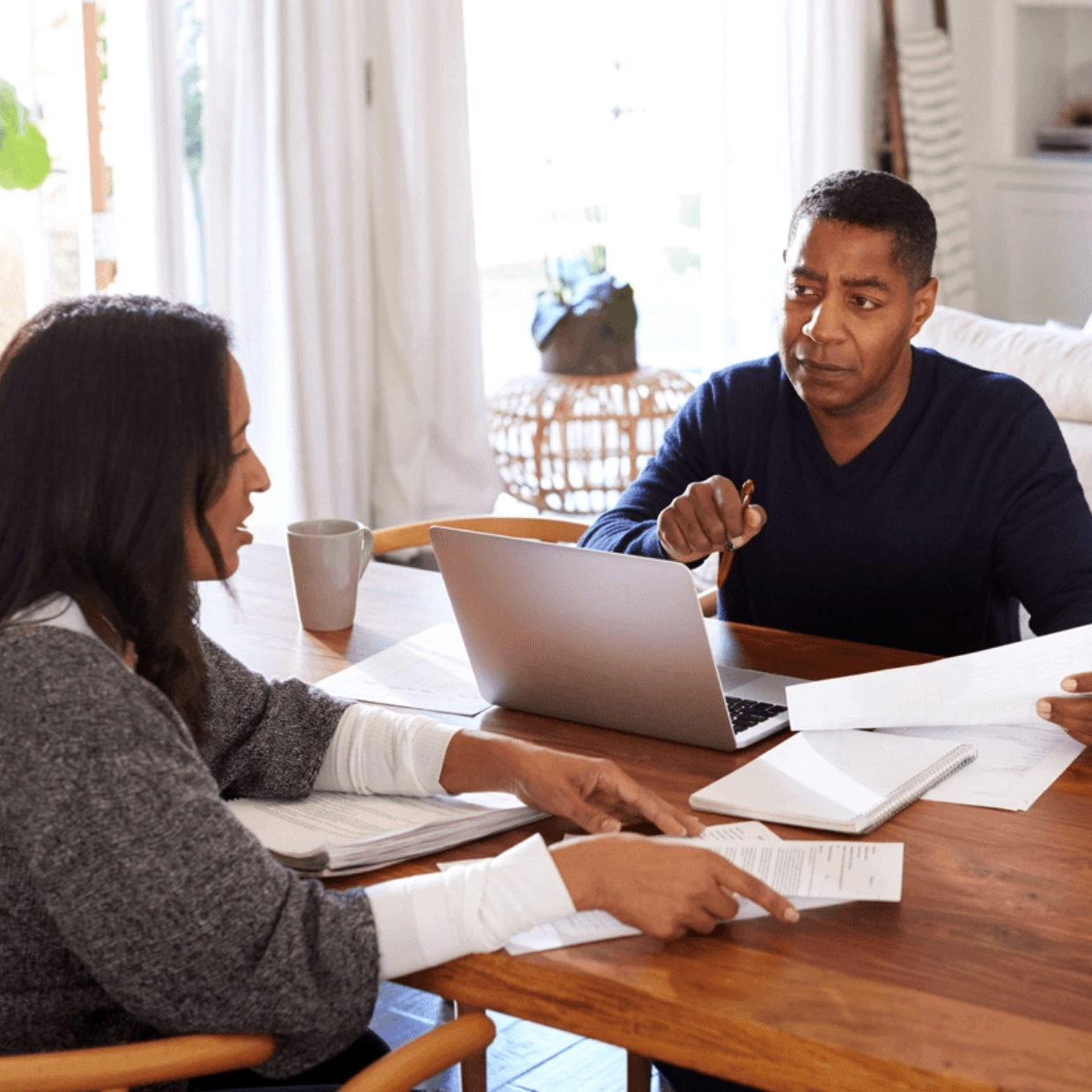 Black Male and White Female Doing Paperwork and On Computer