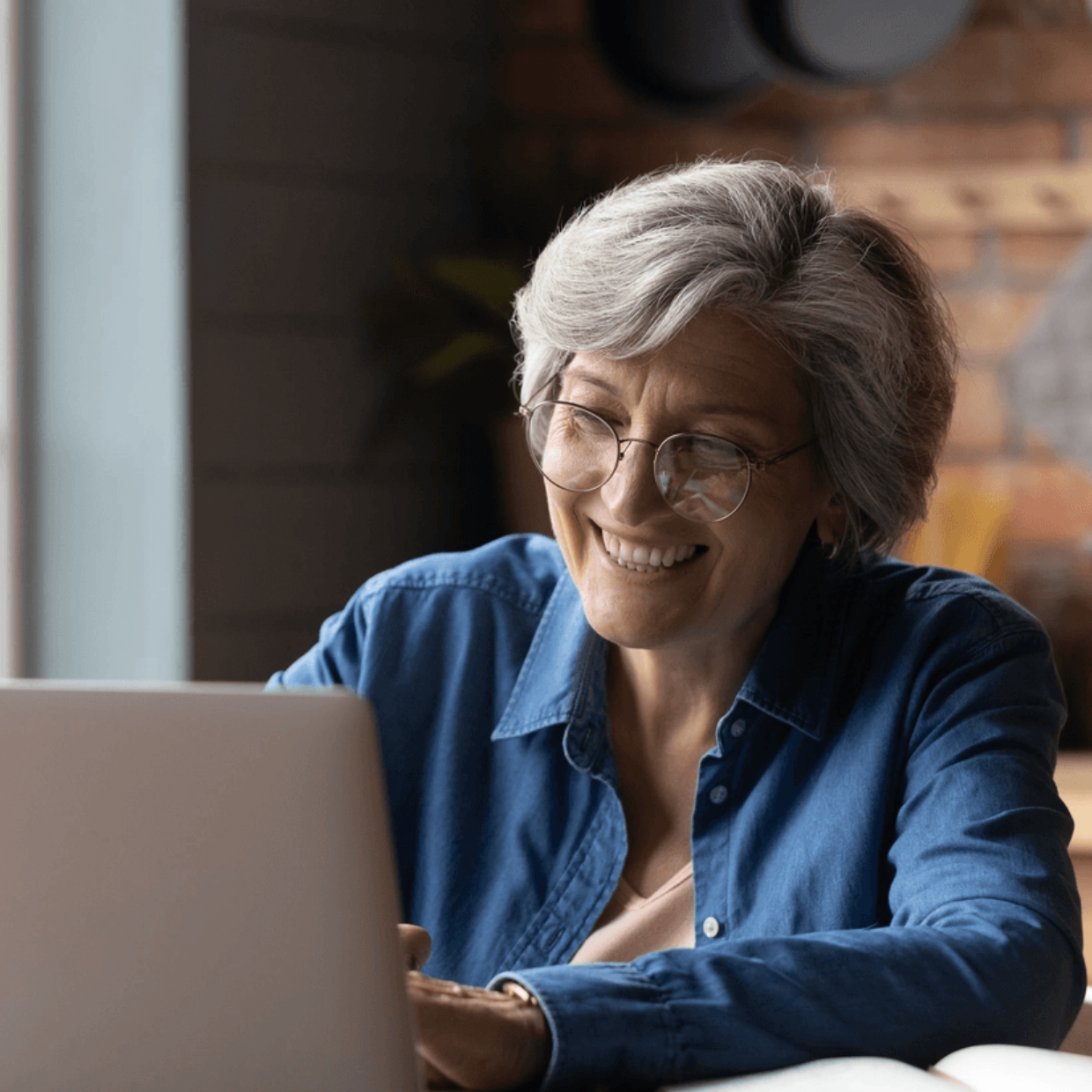 Female Client Denim Shirt Smiling Using Computer STOCK