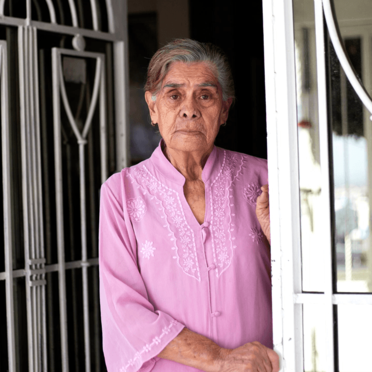 Female Client Pink Shirt Eye Contact Sad At Door