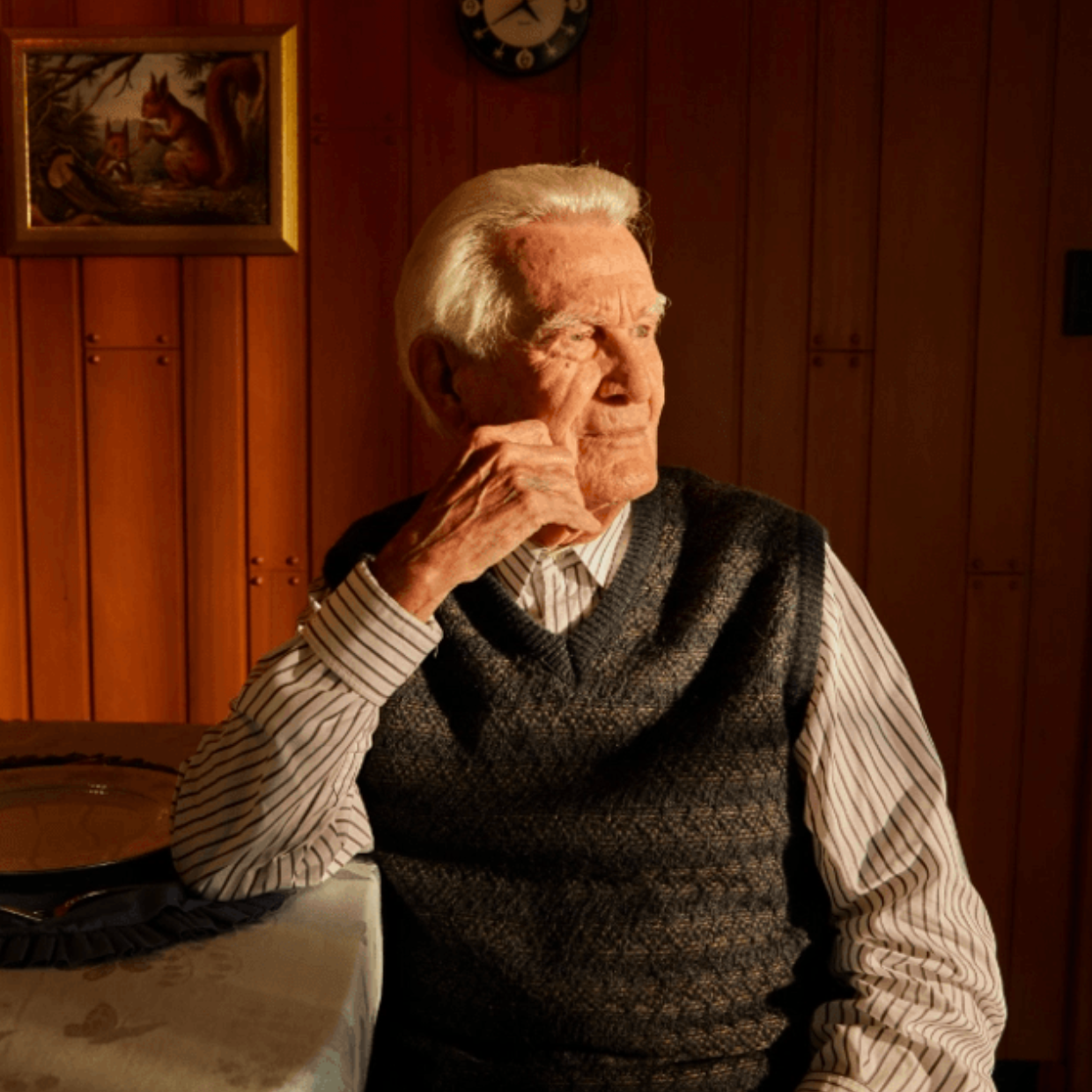 Lloyd Gray Vest Looking Away Sad at Kitchen Table