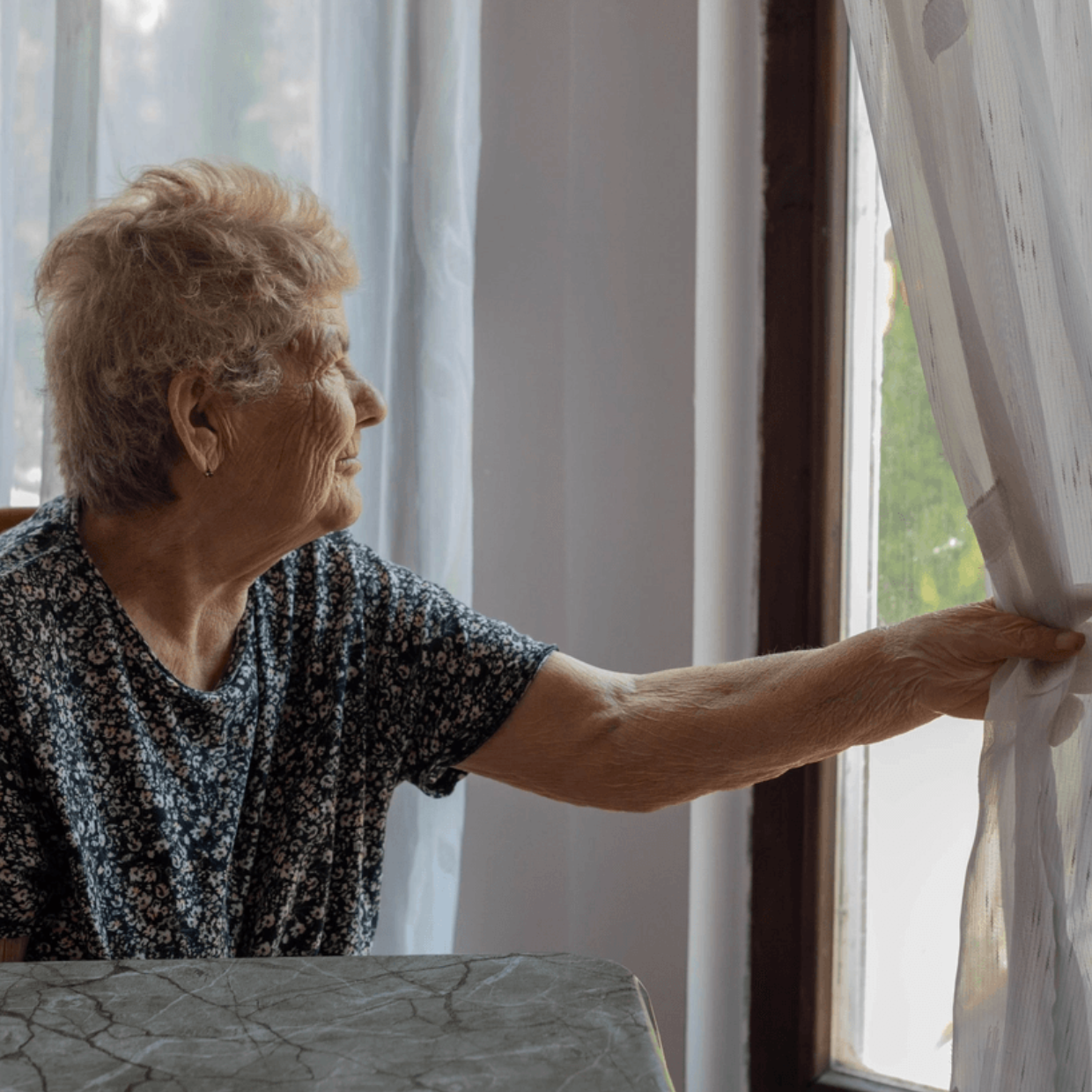 White Female Client Blue Floral Blouse Looking Out Window Longfully