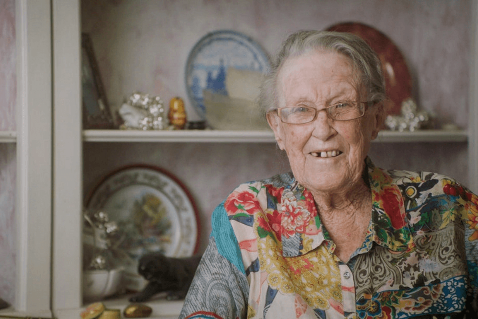 Ruth, Client in Colorful Blouse Smiling in Kitchen - What a Knock on the Door Means to Ruth