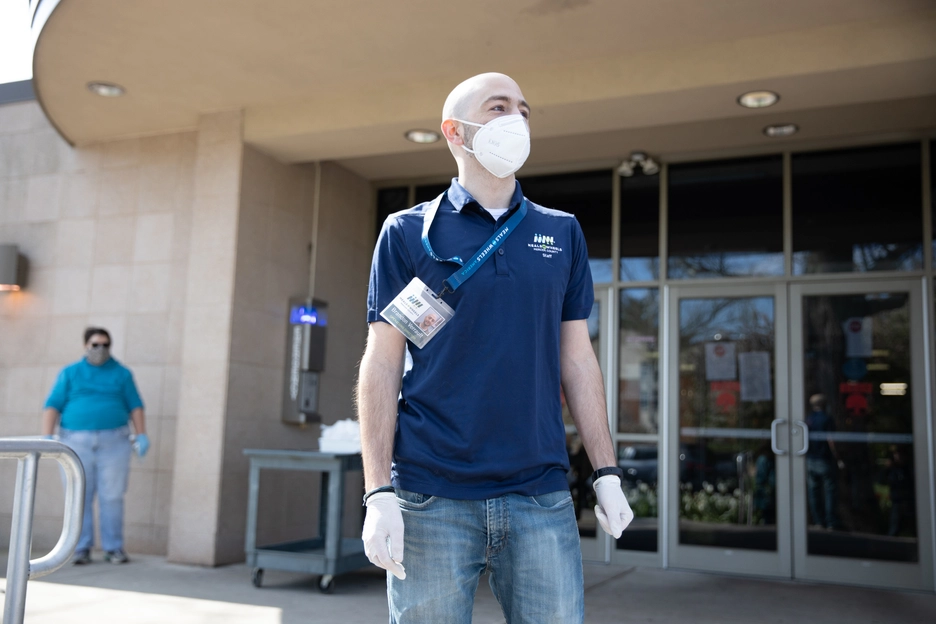 White Male Volunteer MOW Shirt and Lanyard Staring Off Outside