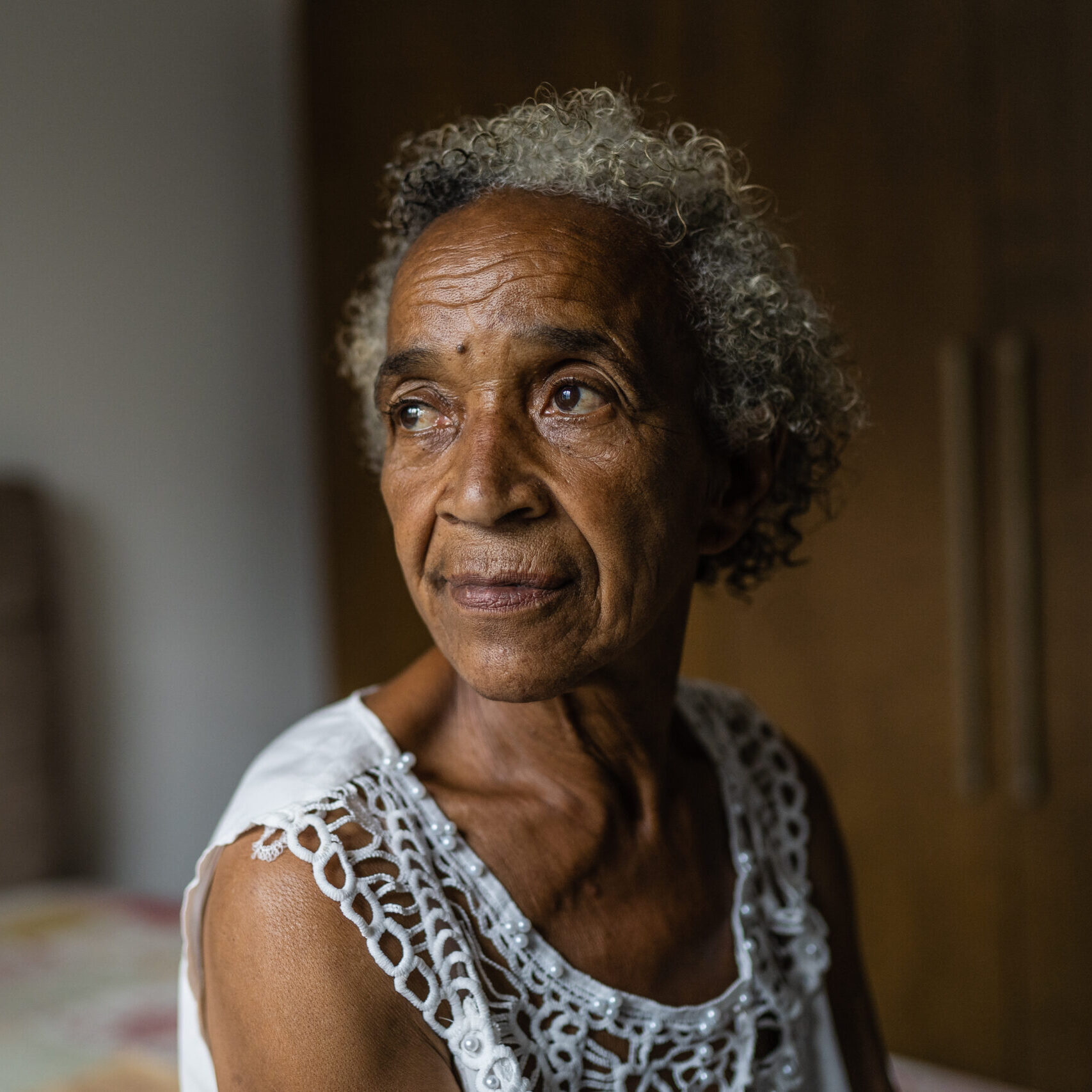 Portrait of an elderly woman in the bedroom