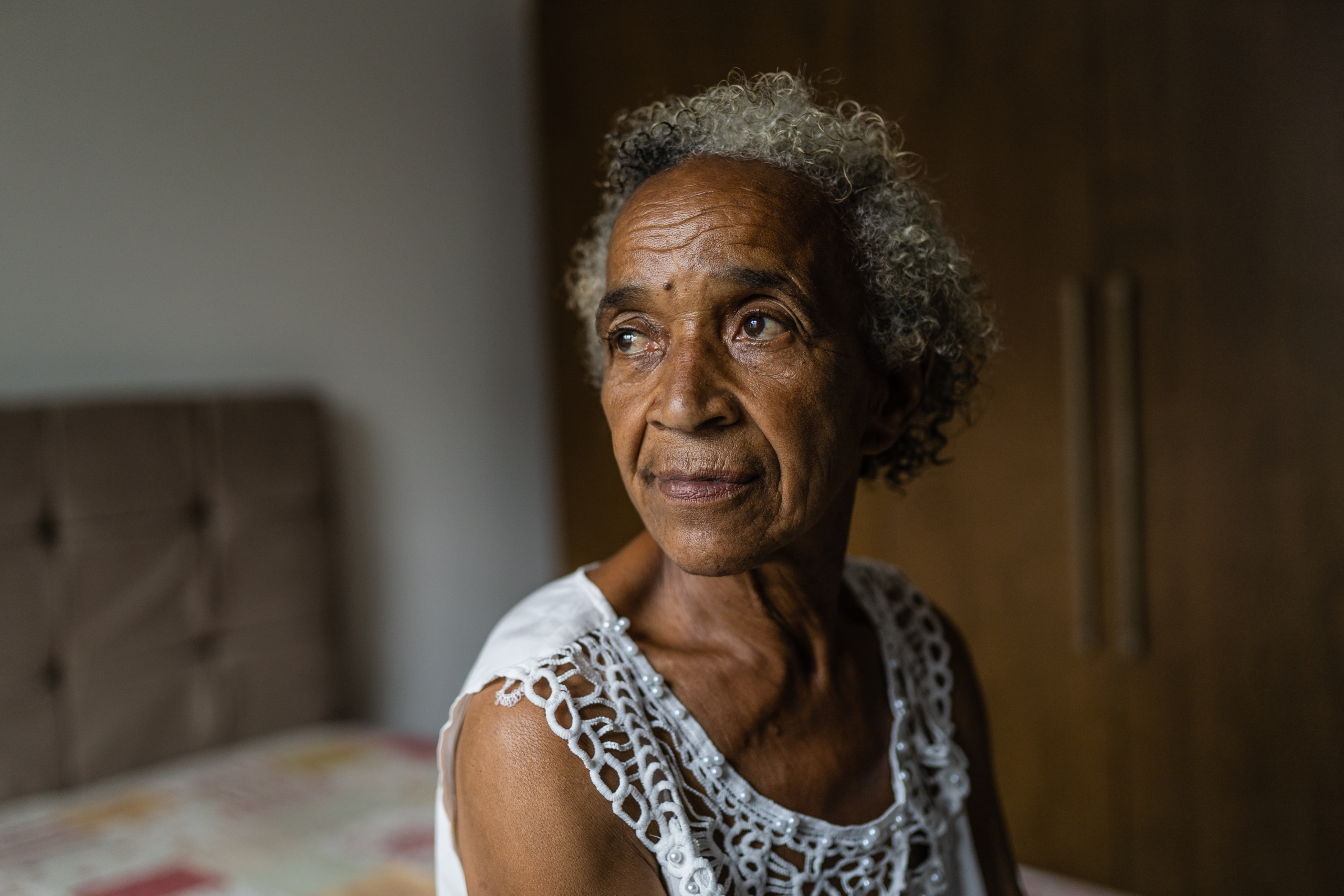 Portrait of an elderly woman in the bedroom