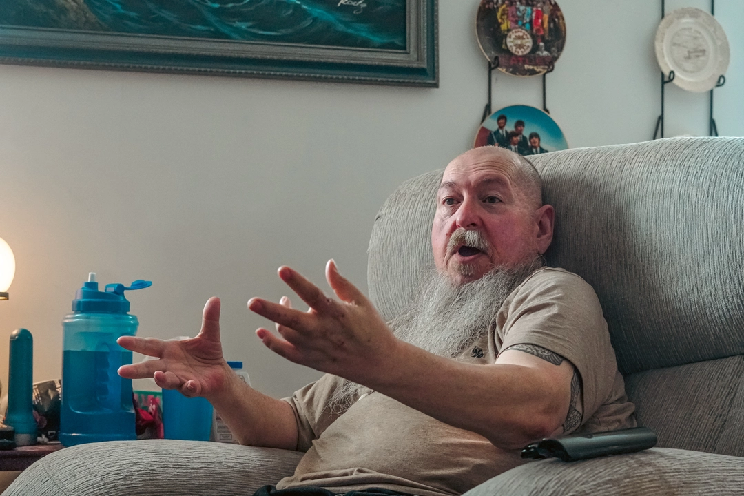 Meals on Wheels Client, Joel Roy, at home sitting in chair - senior independence support
