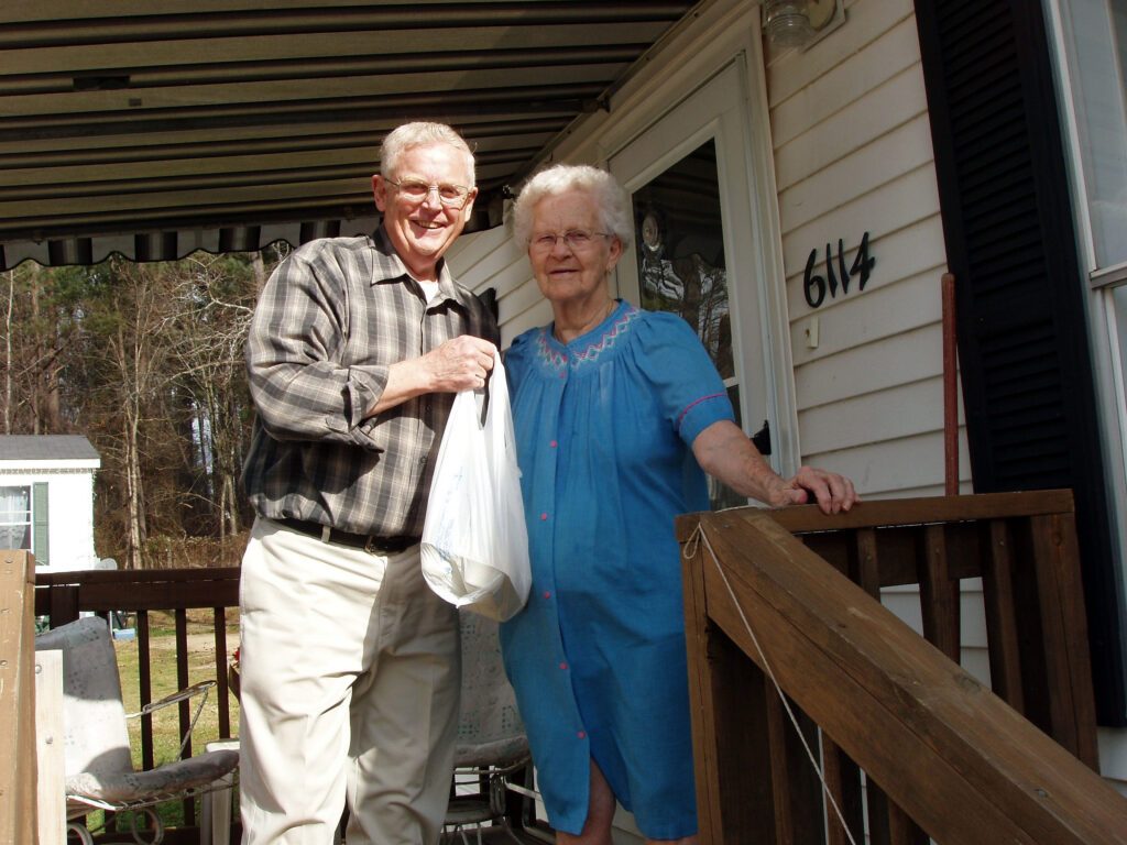 Bob and Mildred on porch with bag showing simple acts of kindness