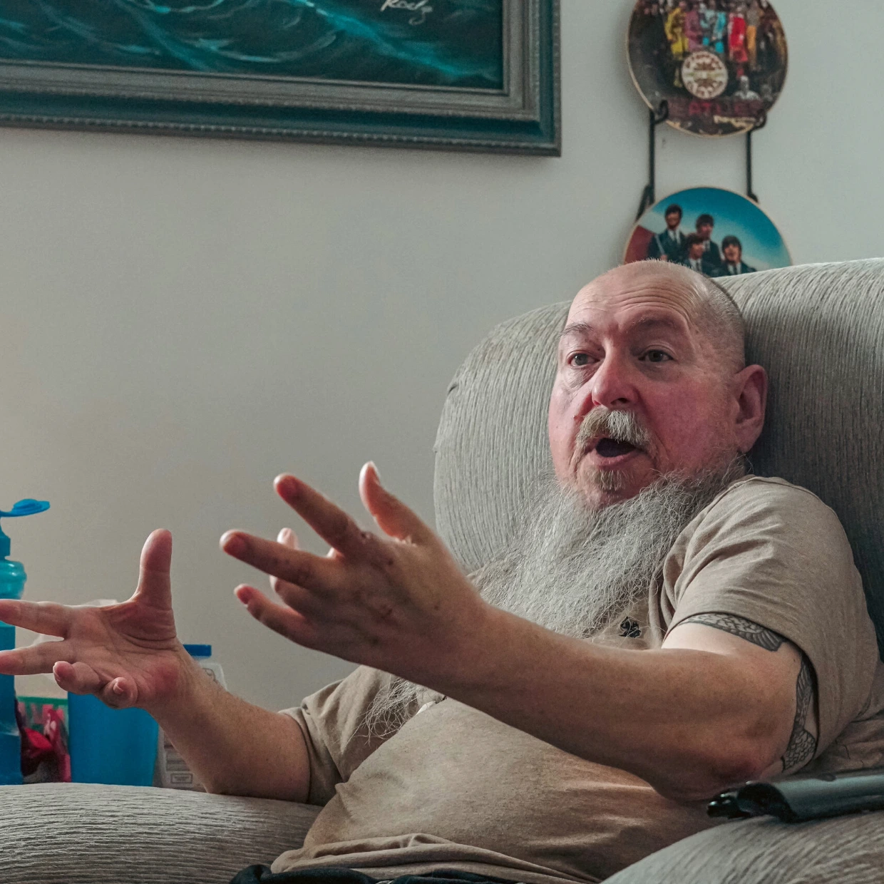 Joel Roy Speaking Passionately in Living Room Chair