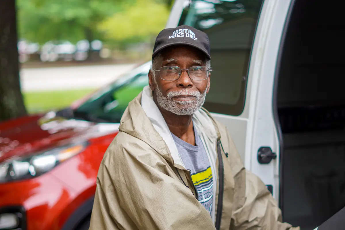 Veteran Ray Hussein delivering a Meals on Wheels meal to a senior at their home