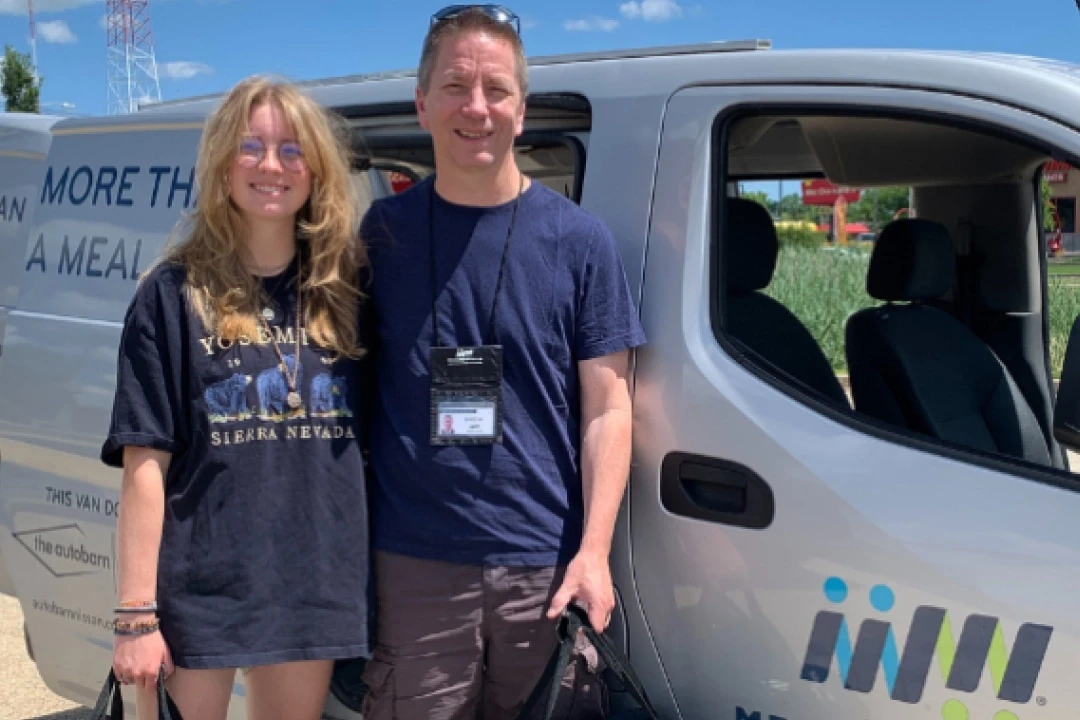 Greg Miller and Sara Miller beside Meals on Wheels van - father daughter community service