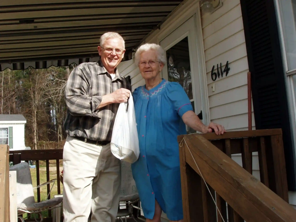 Bob and Mildred on porch with bag showing simple acts of kindness