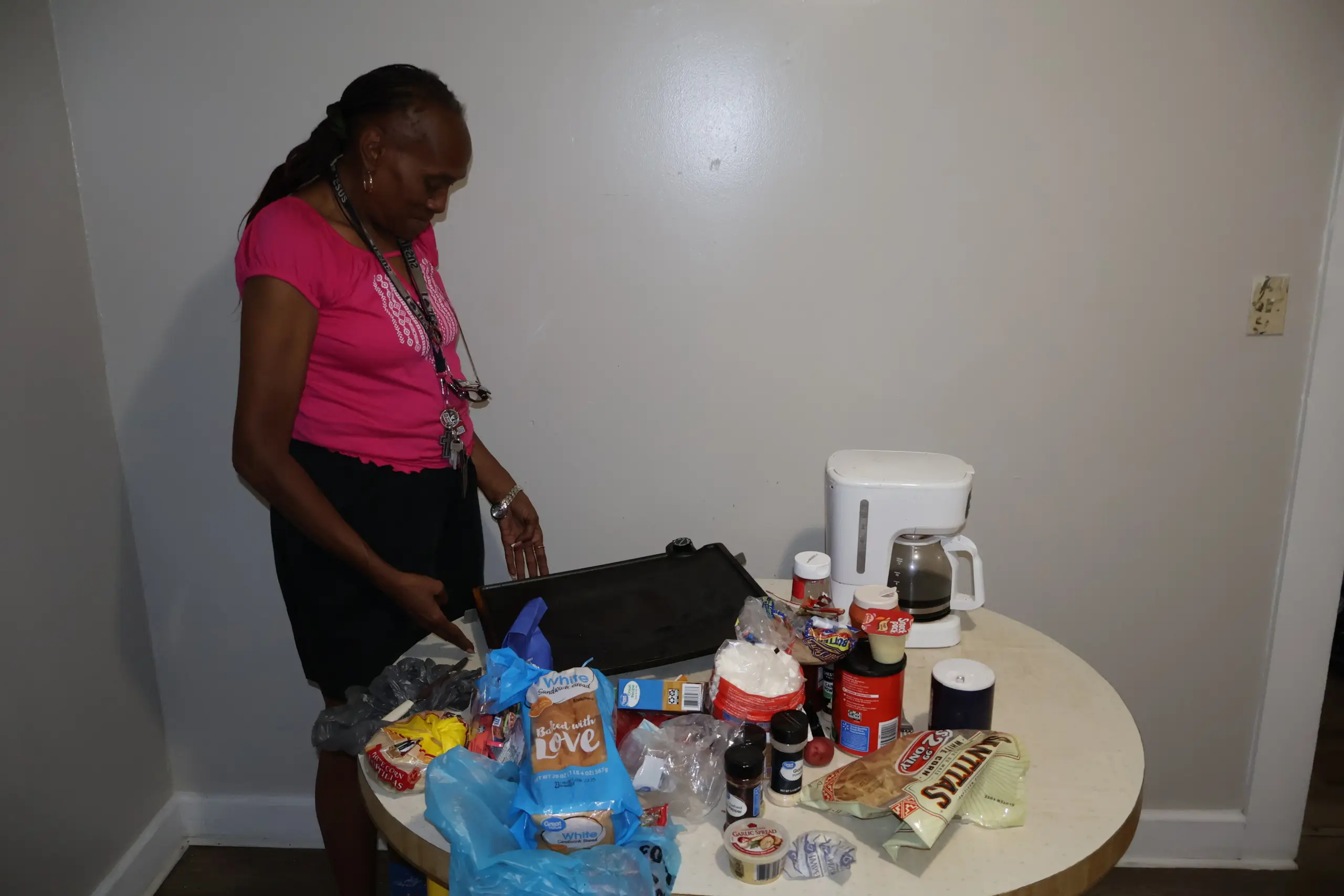Black woman looking at table with a small amount of food