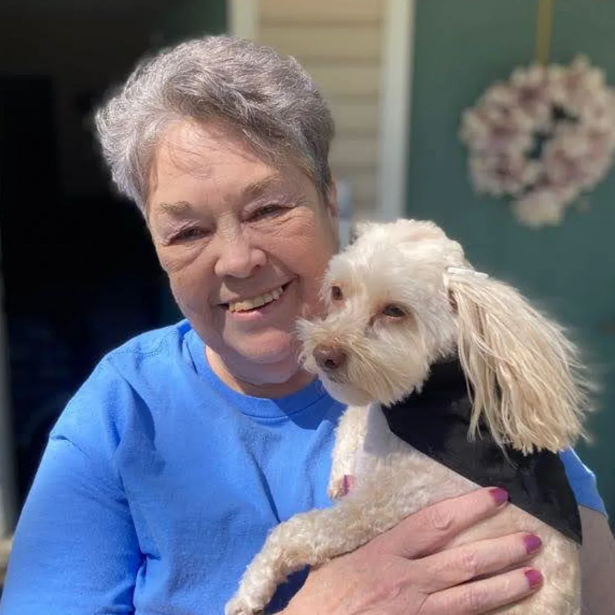 Judy smiling white holding her dad.
