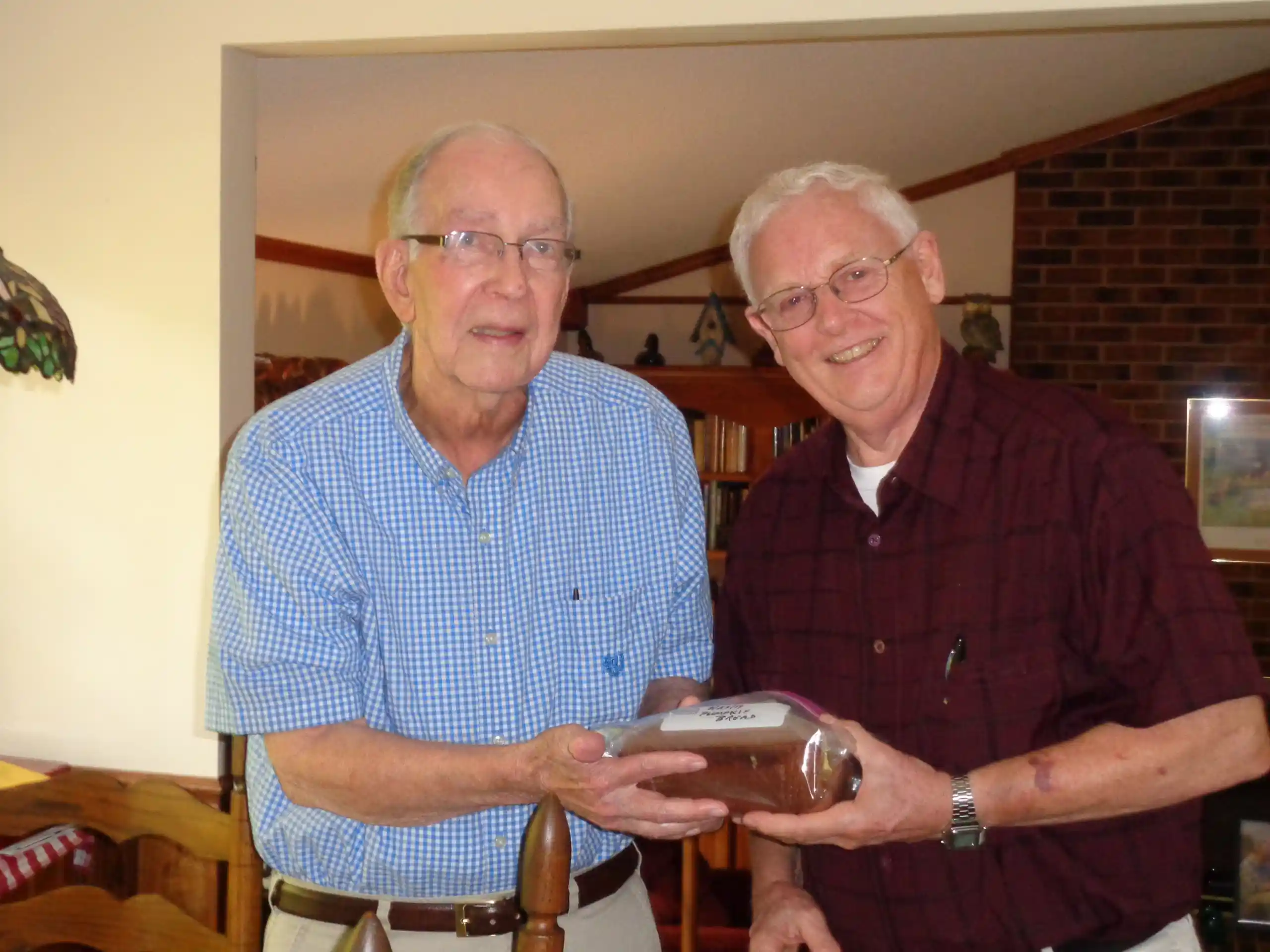 Bob Starkes and Meals on Wheels Recipient Paul with pumpkin bread.