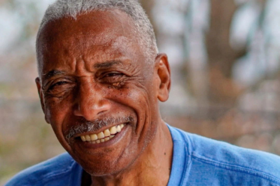 Black male senior Joe Young smiling.