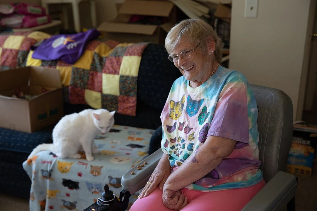 Senior client Joan and her cat, Snowball