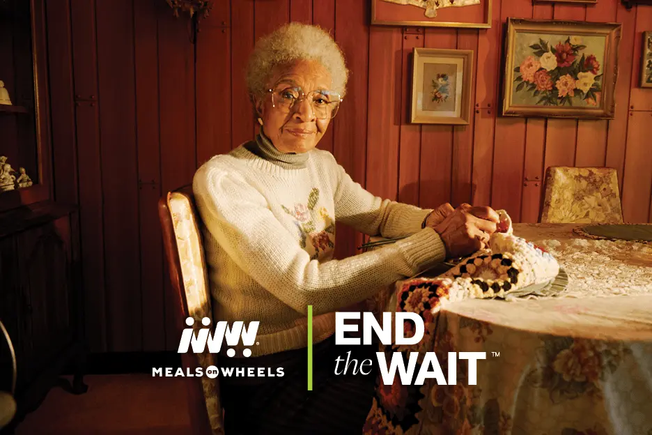 Black Woman at table knitting - End the Wait for Seniors