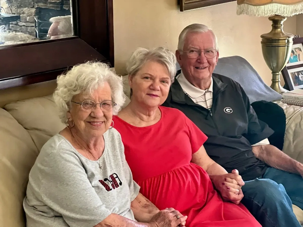 Teresa, Sylvia, and Mike sitting together on a couch